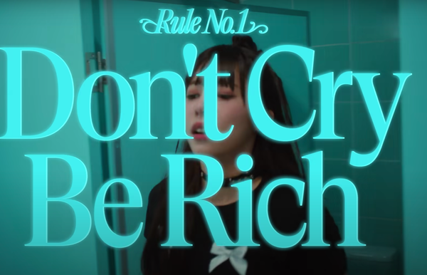  tripleS(트리플에스) LOVElution ‘Girls' Capitalism’ MV screenshot reading "Rule No. 1 Don't Cry Be Rich".